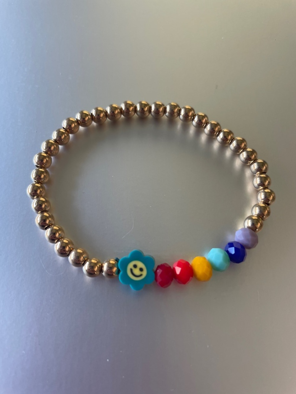 Gold Bead Stretch Bracelet with Blue Smiley Flower and Multicolor Accents